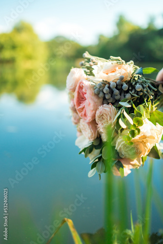 wedding bouquet near the river lake