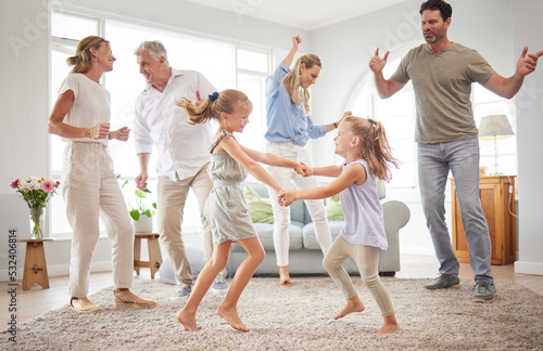 Happy, dance and love with big family in living room together for crazy, energy and excited. Lifestyle, freedom and celebration dancing at modern home with parents, children and grandparents