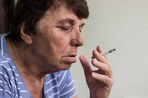 Portrait of mature woman smoke a cigarette