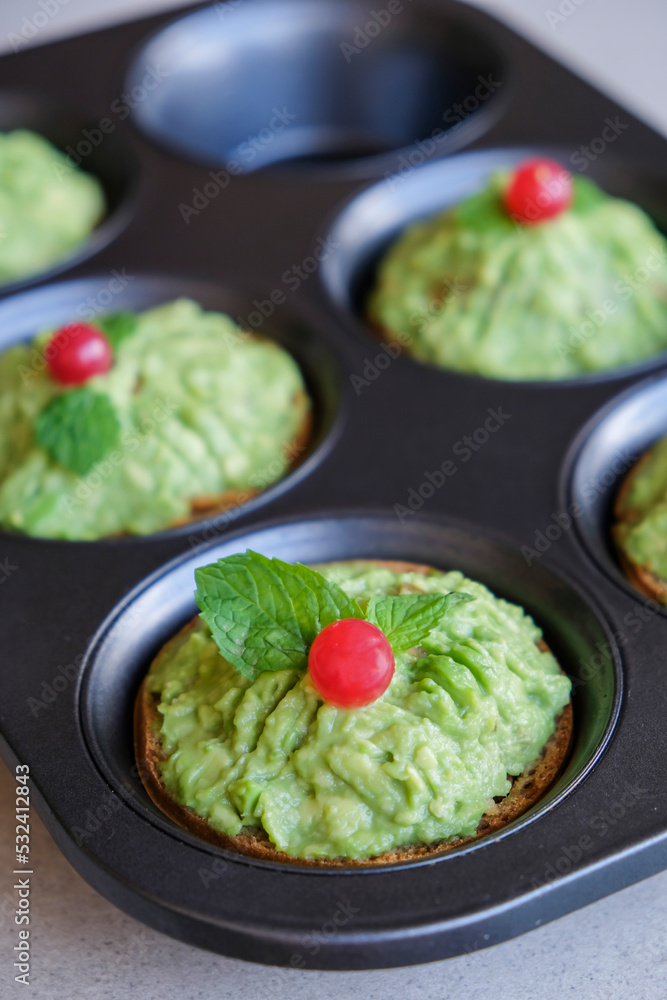 Homemade pastry. Avocado Red Currant Tart. Crispy crust with rich and creamy avocado fillings and top with a red currant, ideal as Christmas snacks, in between meals and tea time