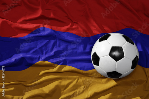 vintage football ball on the waveing national flag of armenia background. 3D illustration