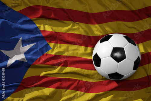 vintage football ball on the waveing national flag of catalonia background. 3D illustration