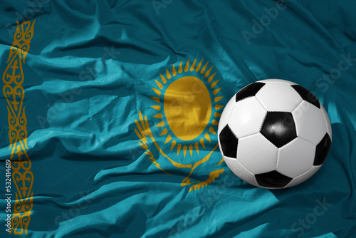 vintage football ball on the waveing national flag of kazakhstan background. 3D illustration
