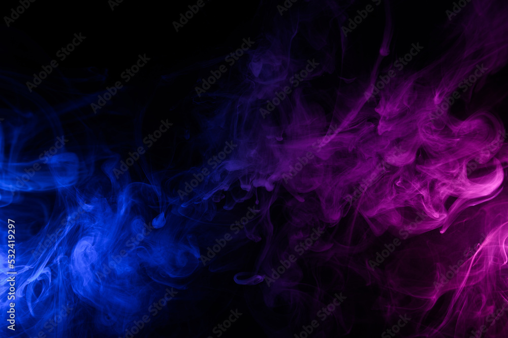 Flowing clouds of colorful swirling blue and pink smoke dark abstract background