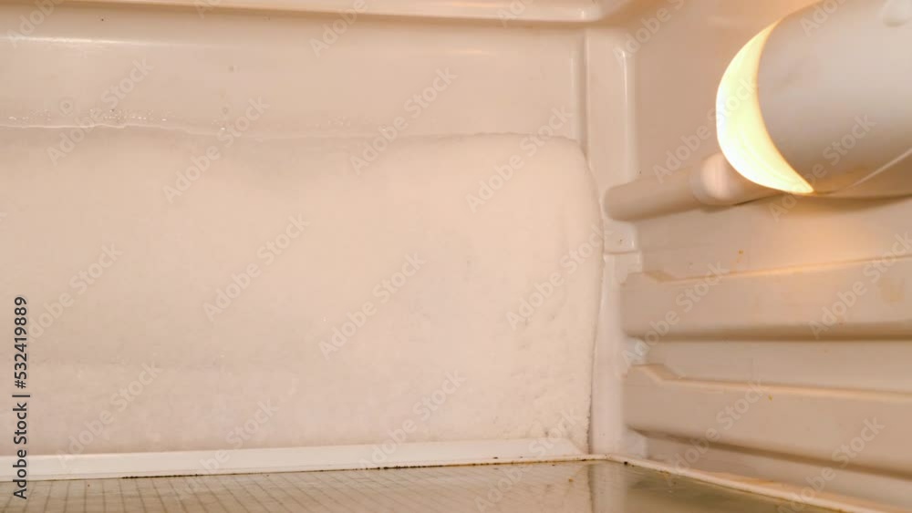 Snow in the refrigerator. Ice on a back wall fridge. Frozen snow. Deep Freezer compartment. Frost and defrost process. The refrigerator needs warranty service of the master in the service workshop Snow in the refrigerator. Ice on a back wall fridge. Frozen snow. Deep Freezer compartment. Frost and defrost process. The refrigerator needs warranty service of the master in the service workshop