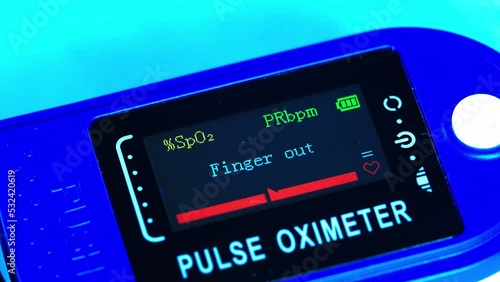 Pulse oximeter Finger out. The medical device shows the level of oxygen in the blood, saturation, pulse rate beats per minute. The pulse of a sick patient on the screen of the medical equipment fades