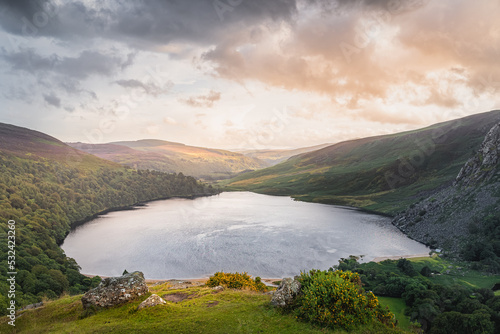 Beautiful and dramatic sunset at Lough Tay  called The Guinness Lake located in deep valley and surrounded by Wicklow Mountains  Ireland