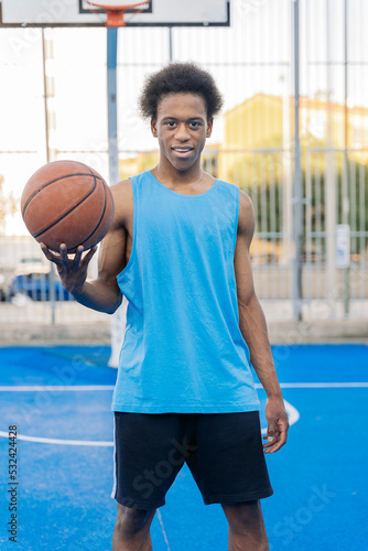 Portrait of a happy basketball player looking at camera