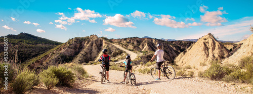 Leinwand Poster family mountain bike in desertic landscape