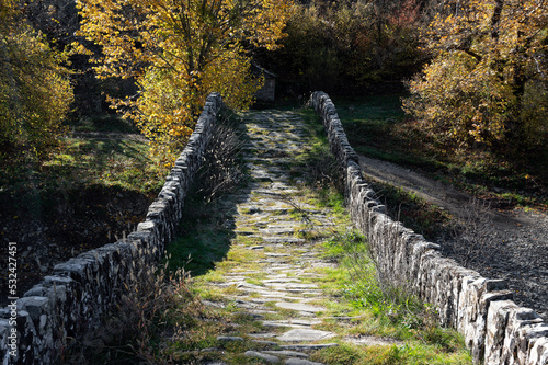 View of the traditional stone Mylos Bridge in Epirus, Greece in Autumn. photo