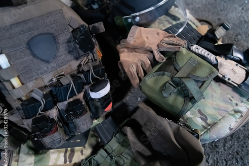 Принти на полотні Army body armor, helmet and ammunition, Kalashnikov assault rifle with matrons and first aid tourniquet composition on brown wood