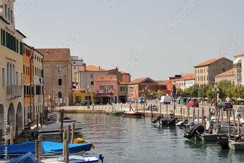 water canal with parked boats, Chioggia town, Italy, canal bridge, water canal streets, classic buildings in Italy, houses with shutters