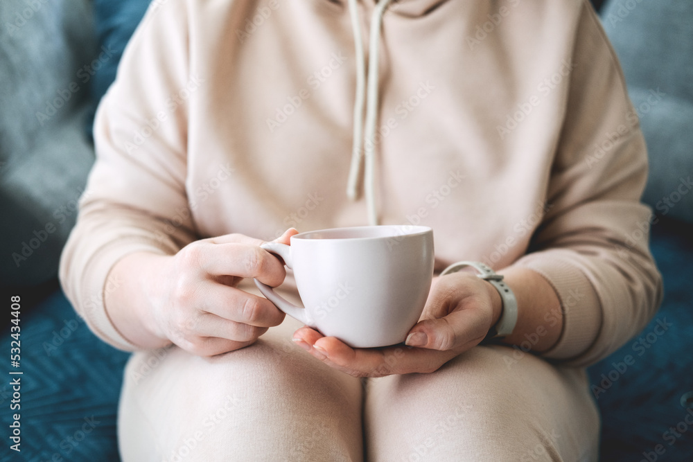 Self care, staying home, cozy mood. Take care of yourself, Love yourself concept. Woman hands with cup of hot drink at home