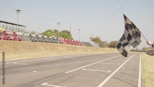 Finishing flag Zwartkops Raceway with go-karts driving past photo