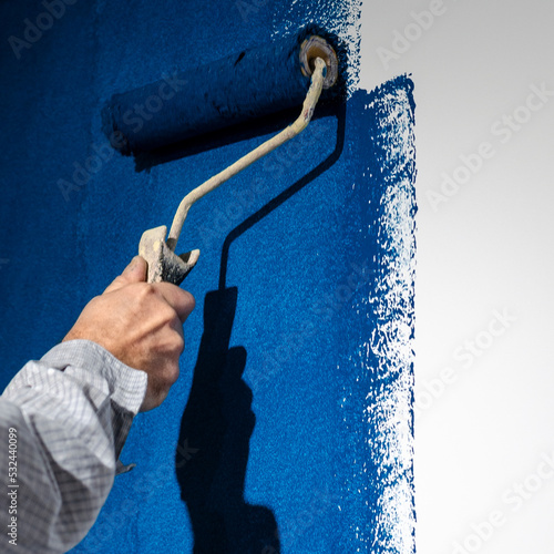 Painting a white wall in blue. Repair