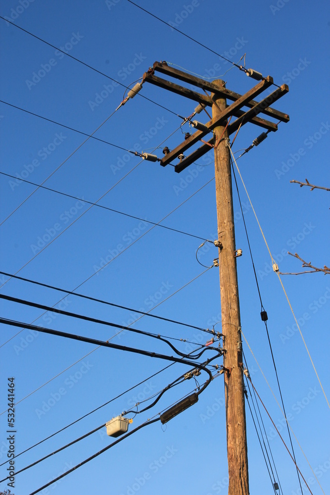 Electric poles made of wood against a dark blue sky scene. in America Electric poles made of wood against a dark blue sky scene. in America