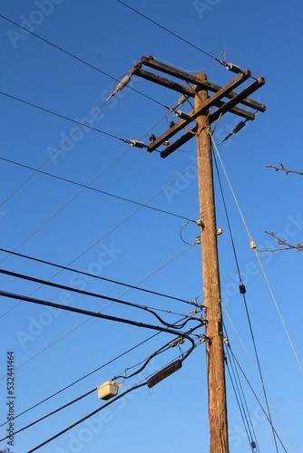 Electric poles made of wood against a dark blue sky scene. in America