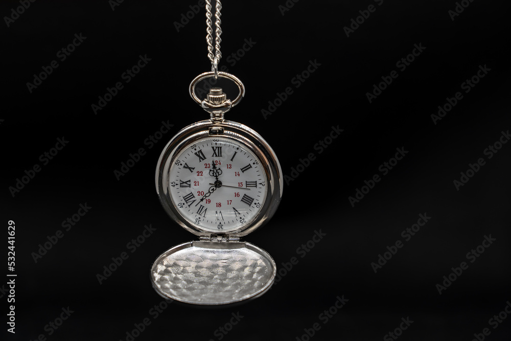An old pocket watch on black background, copy space An old pocket watch on black background, copy space