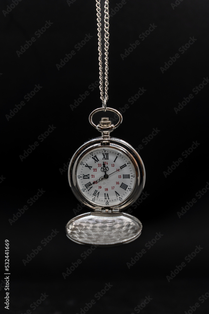 An old pocket watch on black background, copy space An old pocket watch on black background, copy space