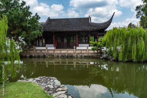 A small building next to a pond in the Suzhou style Bonsai Garden at Jurong Lake Gardens  Singapore.