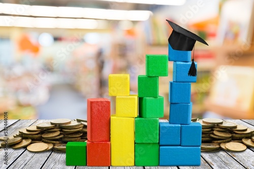 Graduate concept with black cap on colored wooden cubes graph