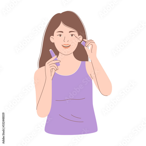 Woman applying mascara