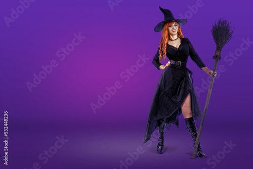 Halloween Witch with broomstick. Female wizard fairy character for All Saints' Day. Fantasy gothic red-haired sorceress girl dressed in black carnival costume