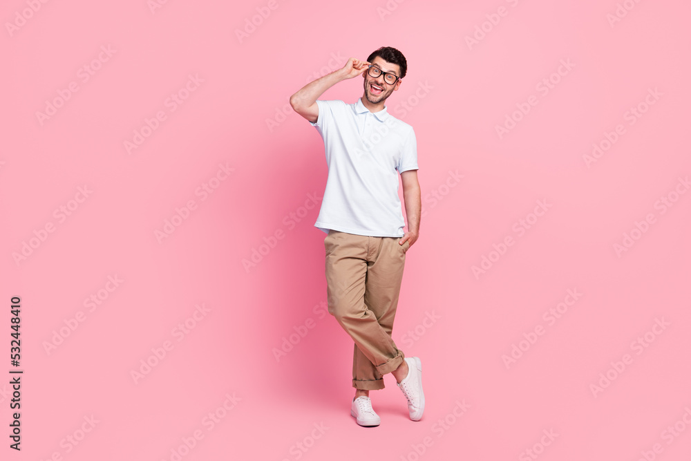 Full length photo of positive man wear fashionable clothes hand pocket touch spectacles stand empty space isolated on pink color background Full length photo of positive man wear fashionable clothes hand pocket touch spectacles stand empty space isolated on pink color background