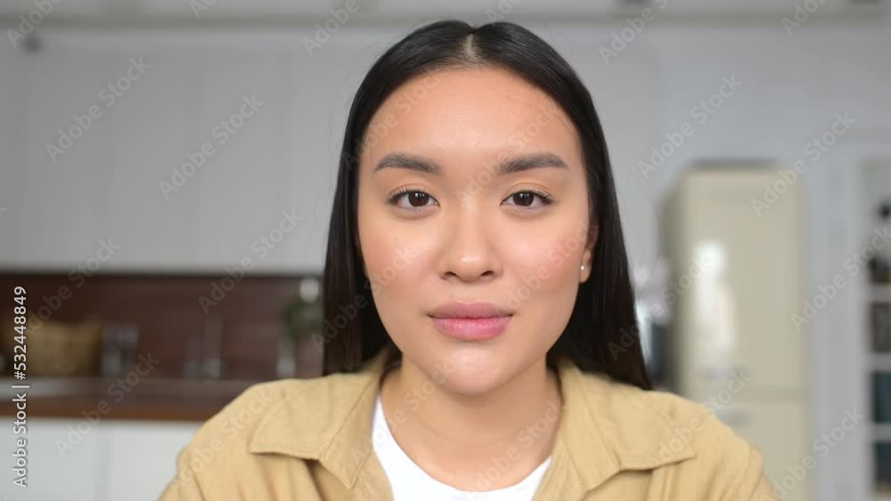 Close-up portrait of charming young asian woman looking at the camera and starts smile toothy, beautiful asian female with bright sight and smooth skin Close-up portrait of charming young asian woman looking at the camera and starts smile toothy, beautiful asian female with bright sight and smooth skin