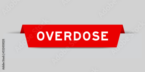Red color inserted label with word overdose on gray background