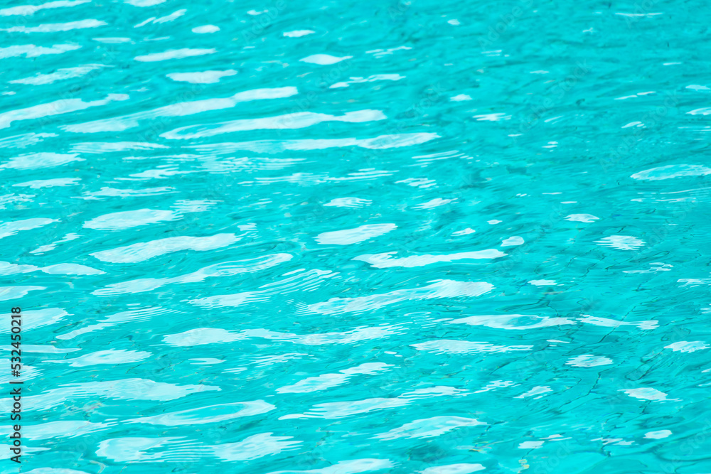 Ripple Water in swimming pool with blue tile floor background Ripple Water in swimming pool with blue tile floor background