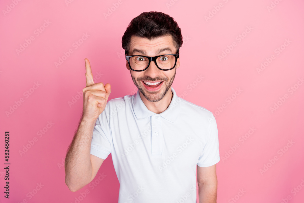 Closeup photo of young handsome positive good mood man wear white polo stylish spectacles glasses point finger idea solution isolated on pink color background Closeup photo of young handsome positive good mood man wear white polo stylish spectacles glasses point finger idea solution isolated on pink color background
