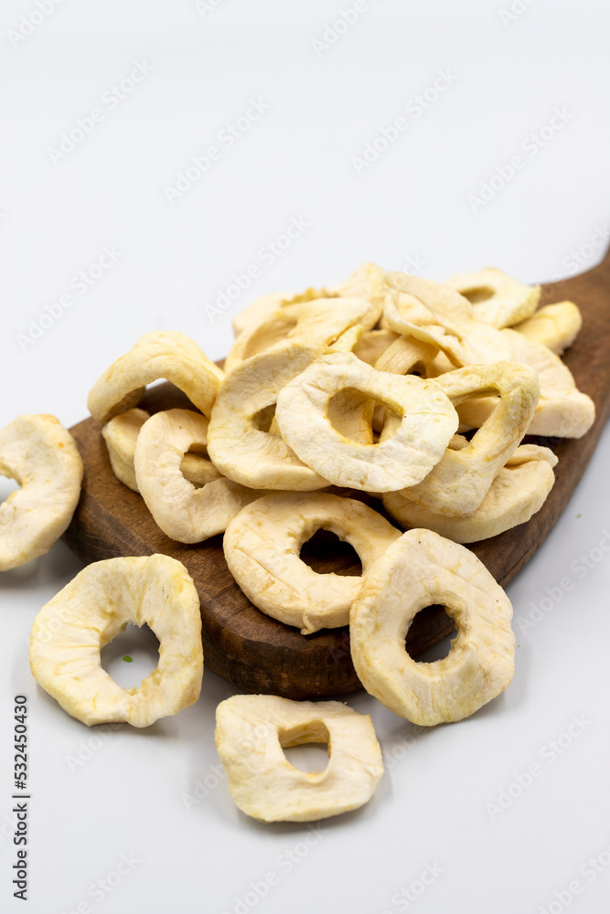 Naklejka premium Dried apple slice isolated on white background. Dried fruit in sunlight. close up