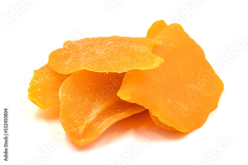 Dried mango slice isolated on white background. Dried fruit in sunlight. close up