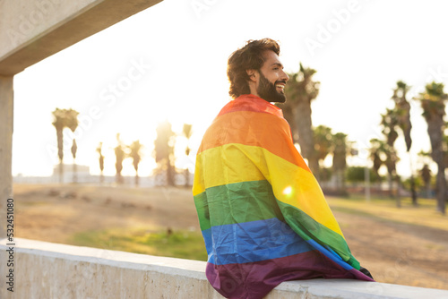 Happy man with a pride flag. LGBT community. © JustLife