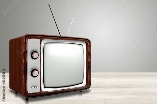 Vintage old television on table and wall background.