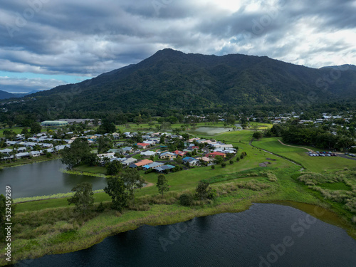 Aerial photo of lake with a mountain backdrop and cloudy sky