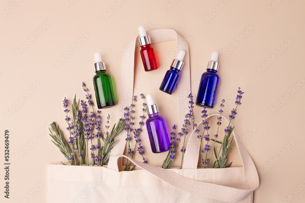 Open eco friendly cotton reusable bag with the different containers.Pastel colors.Natural lavender around.Concept of organic,zero waste cosmetics.Woman bag with accessories. Open eco friendly cotton reusable bag with the different containers.Pastel colors.Natural lavender around.Concept of organic,zero waste cosmetics.Woman bag with accessories.