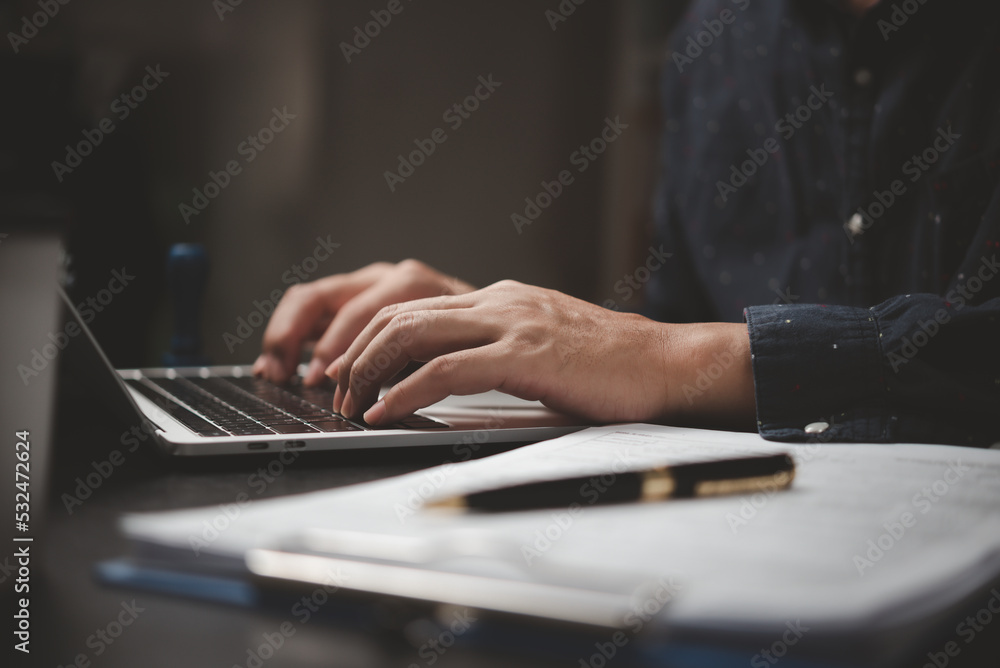 Businessman working laptop computer hand typing keyboard computer office technology communication internet on desk.