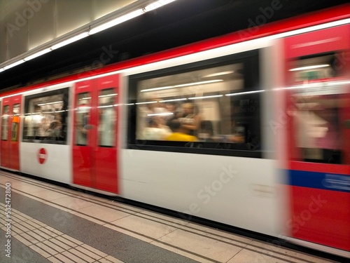 Wide angle view of an electric train accelerating with motion blur in a metro station in Barcelona, ​​Spain. Travel and public transport concept.