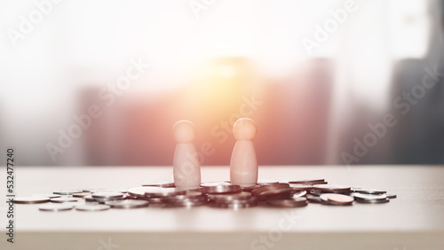 Business contact and financial concept. Two wooden figures standing on piles of coins, business negotiations, trading dealings, brokers.