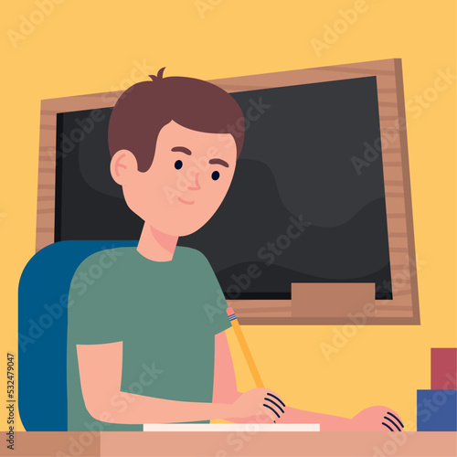 schoolboy writing in book