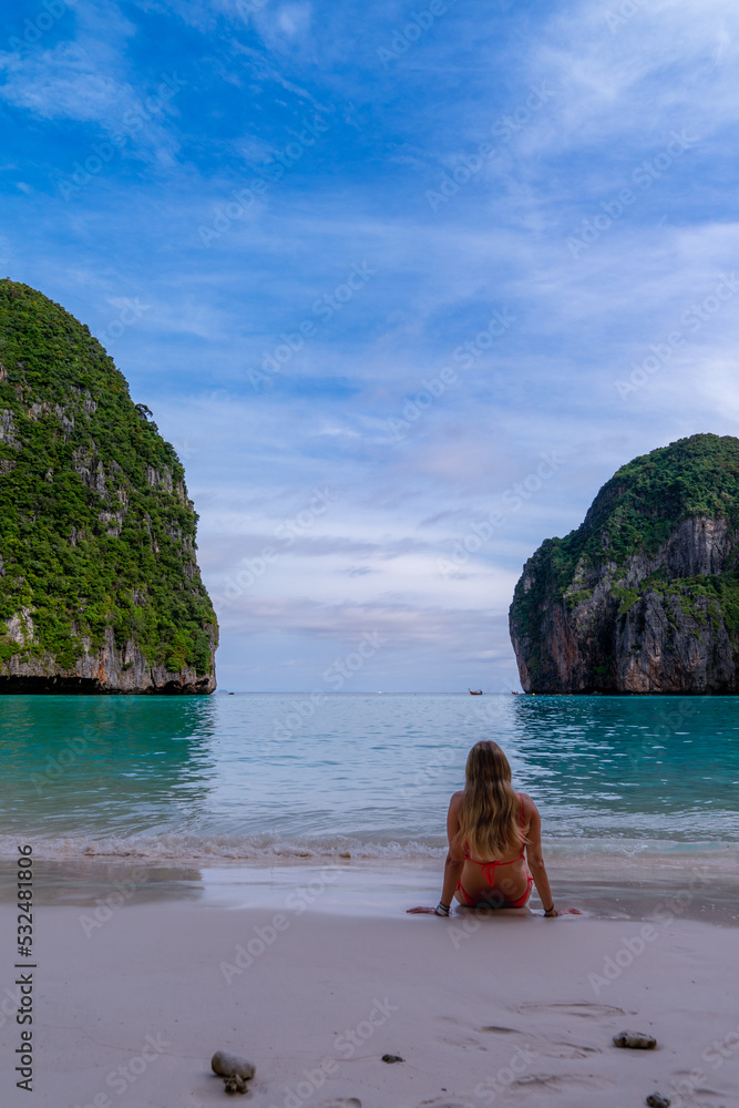 Woman lying on the sand at Maya Bay on Phi Phi Island in Thailand. Trip. Paradise