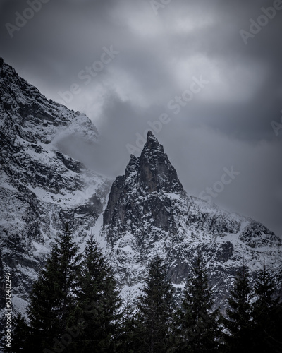 Fototapeta Naklejka Na Ścianę i Meble -  National park of High Tatras in Poland, Landscape photography in the winter. Mountains peaks of Tatry Wysokie with moody conditions