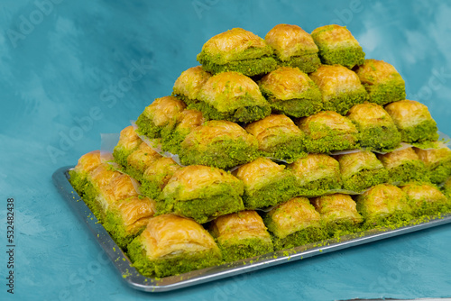 Image of baklava with pistachio stacked on a tray