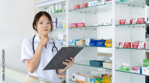 Pharmacist working in a pharmacy, Consultation and medical advice, All kinds of generic household drugs and pharmaceutical products on the shelf, Service and assistance to patients, Pharmacy. © Puwasit Inyavileart
