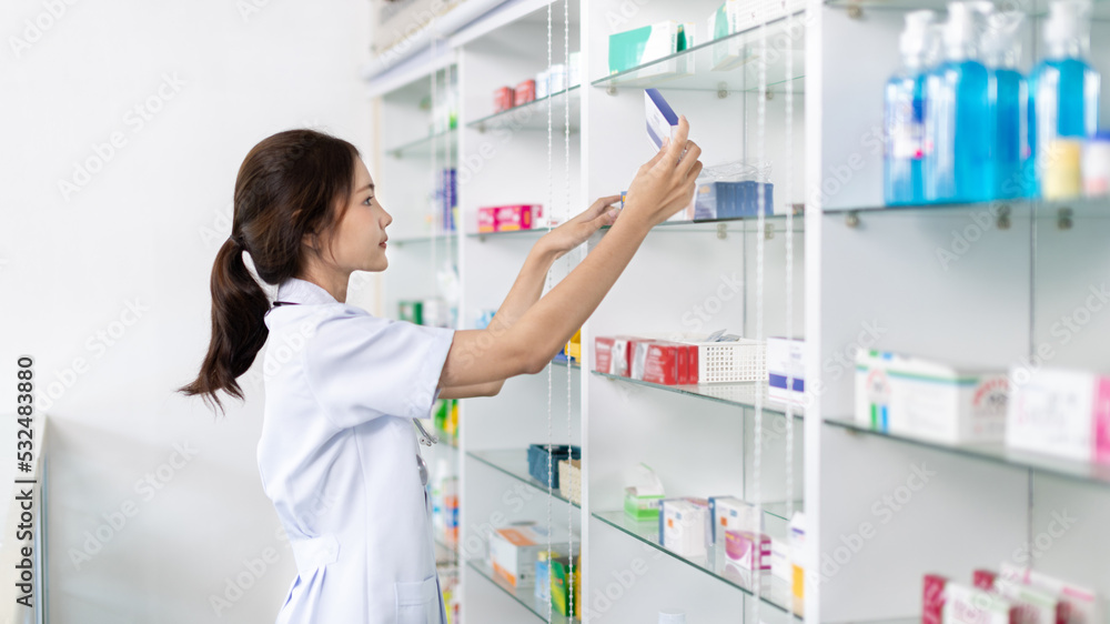 Pharmacist picks up pills on shelf from doctor's prescription, All kinds of generic household drugs and pharmaceutical products on the shelf , Administering medications as prescribed by the doctor.