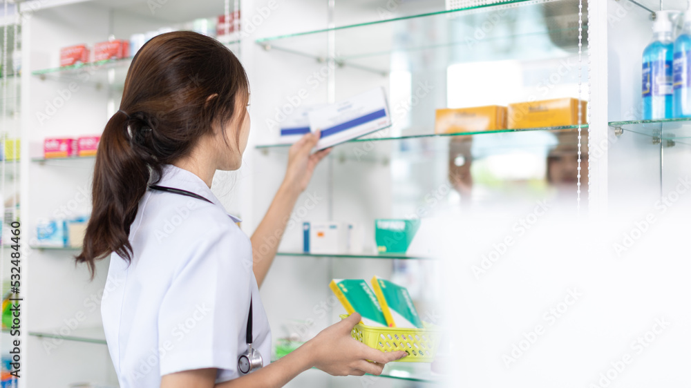 Pharmacist picks up pills on shelf from doctor's prescription, All kinds of generic household drugs and pharmaceutical products on the shelf , Administering medications as prescribed by the doctor. Pharmacist picks up pills on shelf from doctor's prescription, All kinds of generic household drugs and pharmaceutical products on the shelf , Administering medications as prescribed by the doctor.