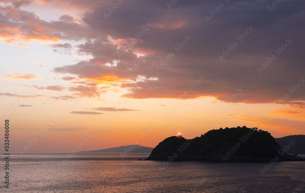 Lighthouse and sunrise in Getaria and the Cantabrian Sea, Basque Country coast.