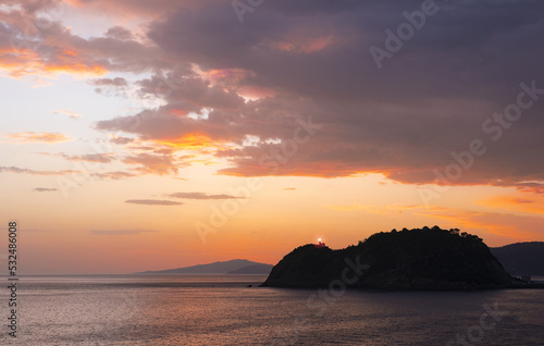 Lighthouse and sunrise in Getaria and the Cantabrian Sea, Basque Country coast. © poliki